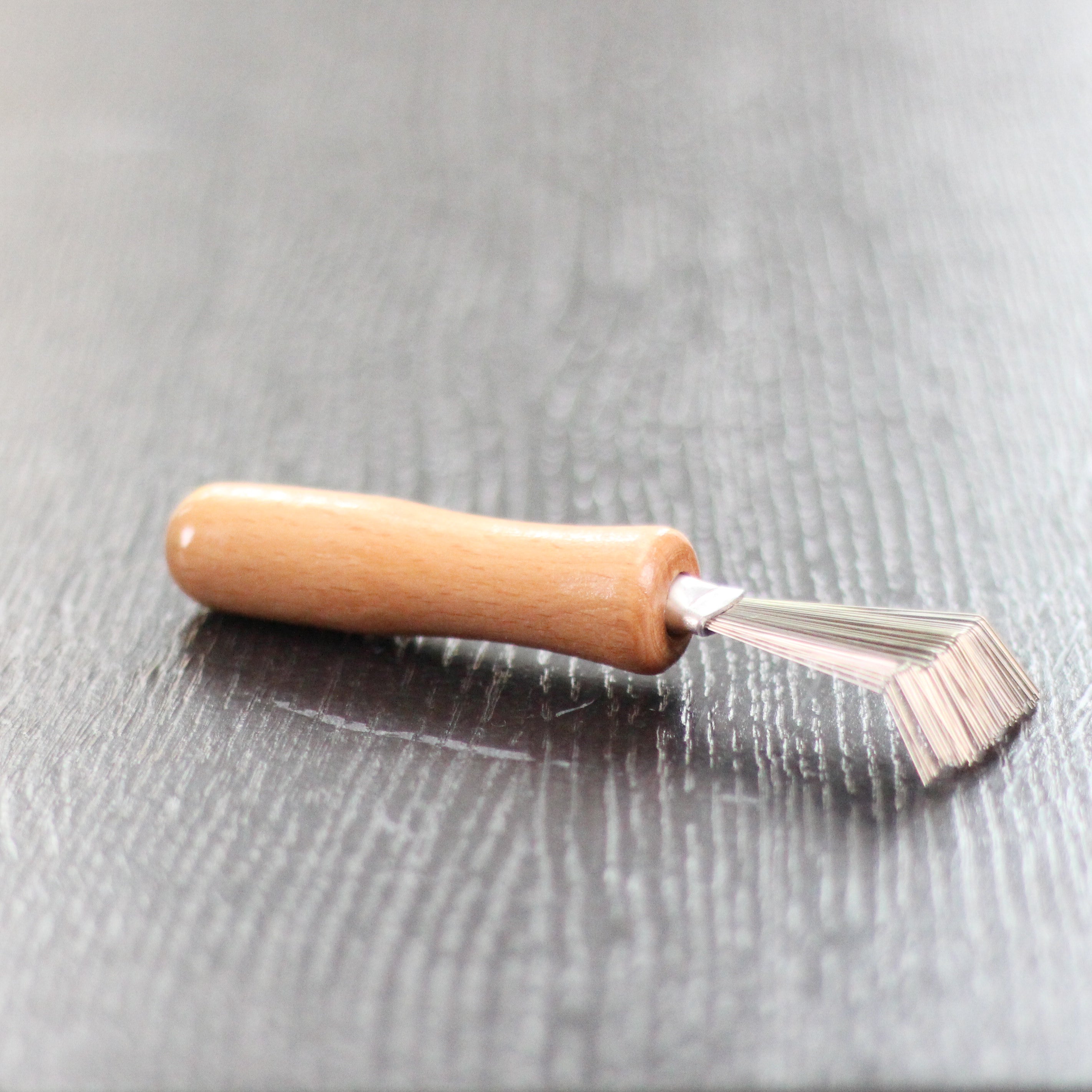 Close-up of Kenzan Rake showing fine teeth perfect for removing dirt and plant material